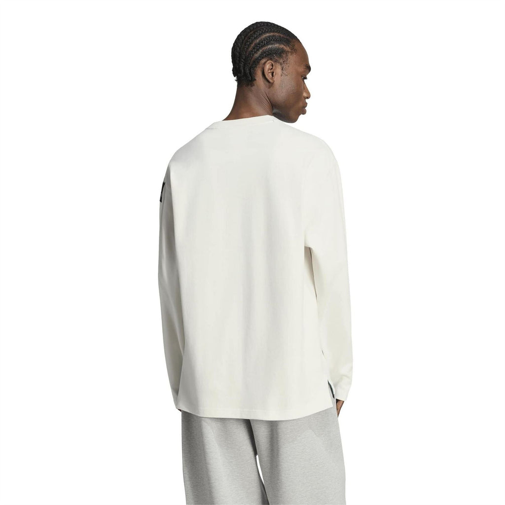 Off-white long-sleeve top, back view with small logo tag on sleeve