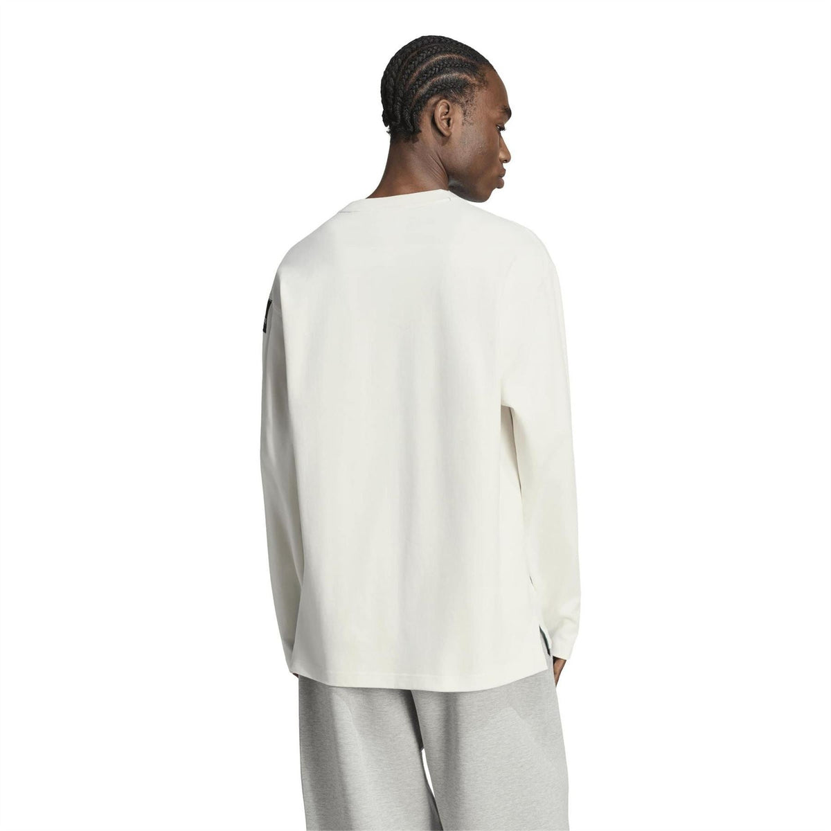 Off-white long-sleeve top, back view with small logo tag on sleeve