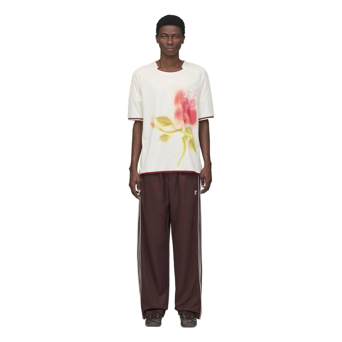 Track pants in dark maroon with white side stripes and elastic cuffs for relaxed wear.