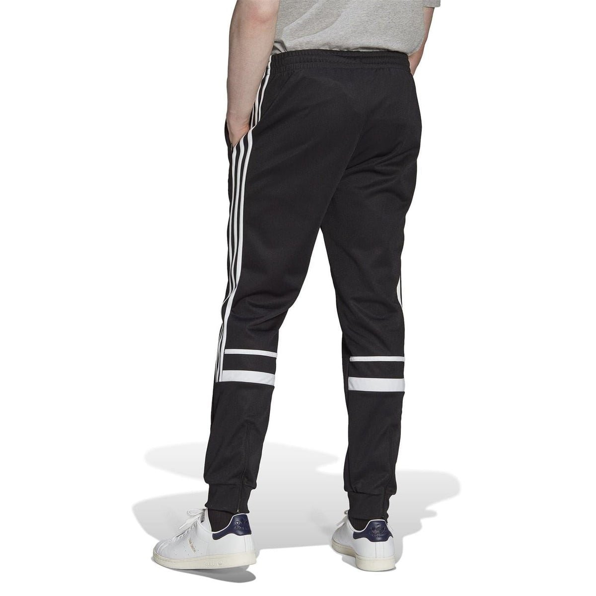 Black adidas Originals joggers, white three-stripe detailing down the outer legs, tapered fit