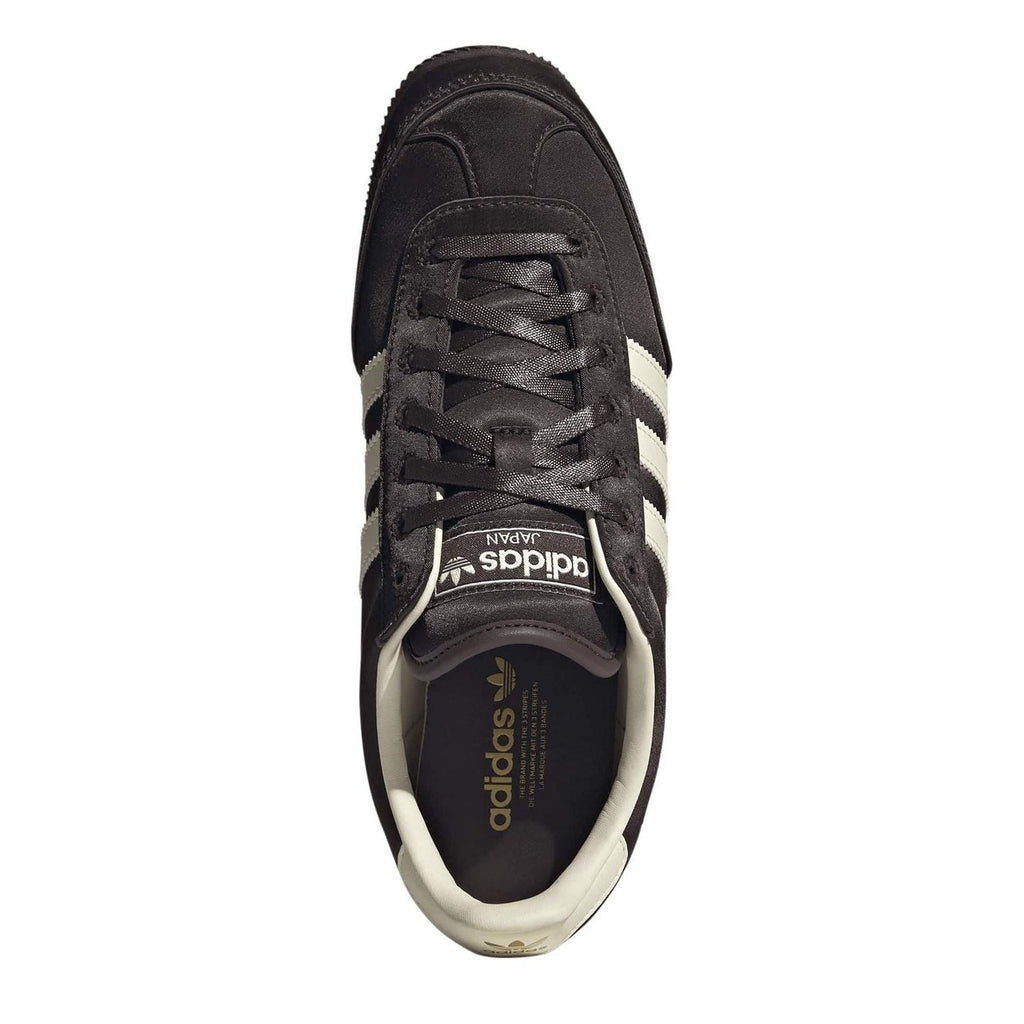 Adidas Originals lace-up sneakers with tongue label and black laces on dark upper