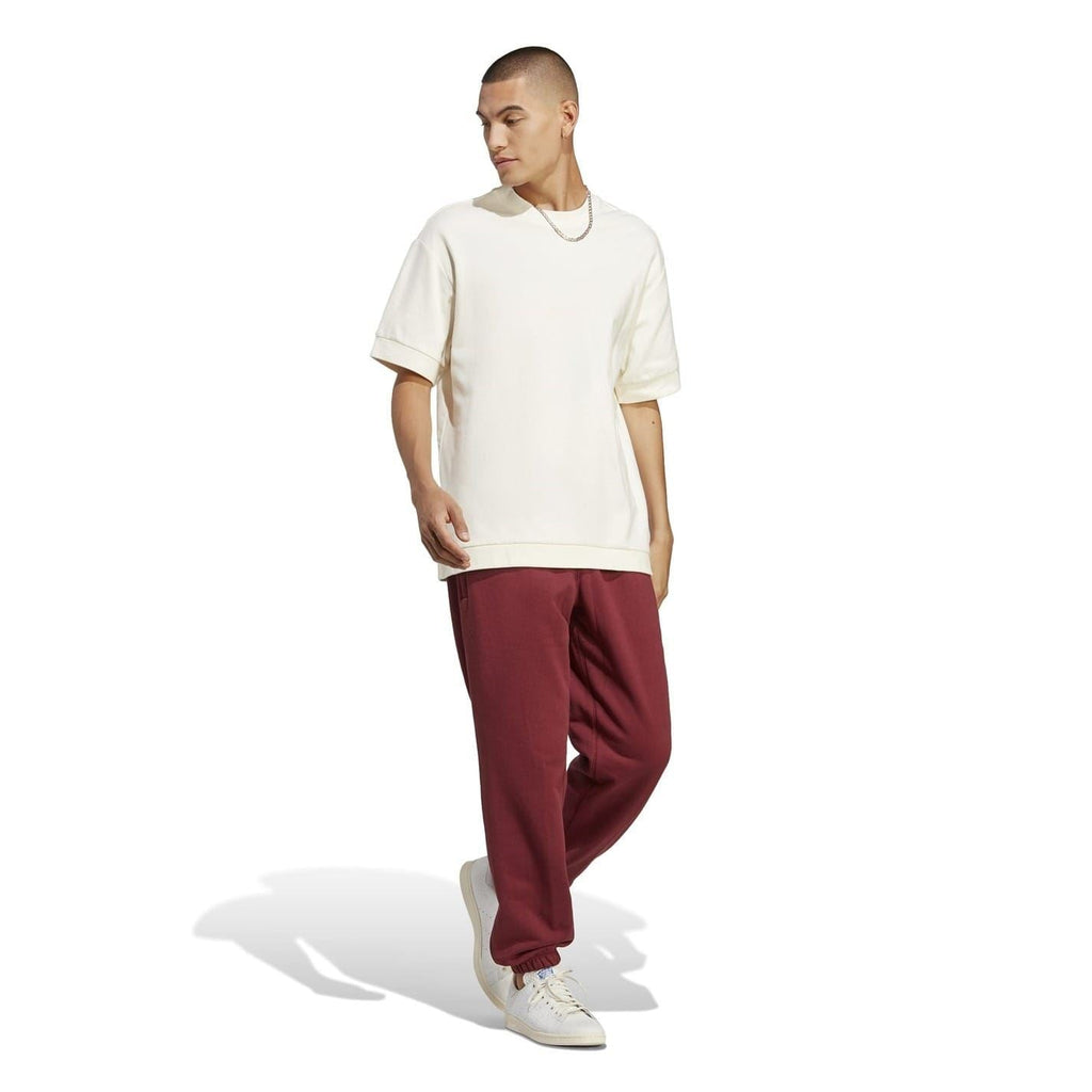 Burgundy track pants with relaxed tapered leg and elastic ankle cuffs