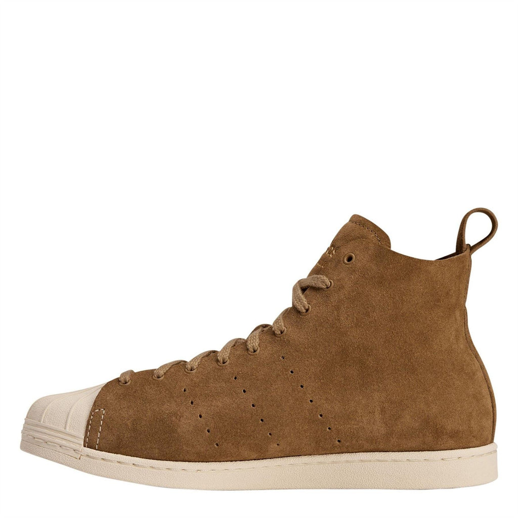 Brown suede high-top sneaker with lace-up, perforated toe and cream rubber sole