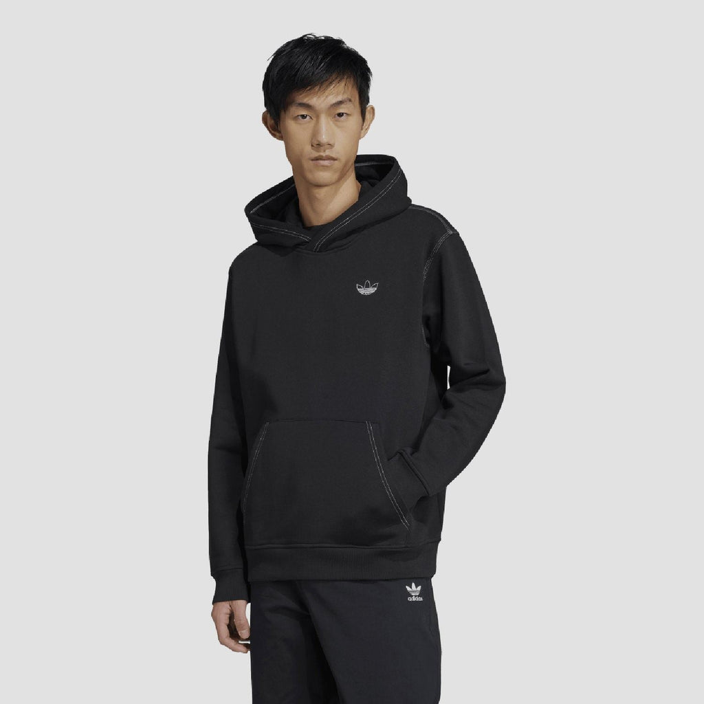 Black adidas Originals hoodie worn by model, with trefoil logo and kangaroo pocket