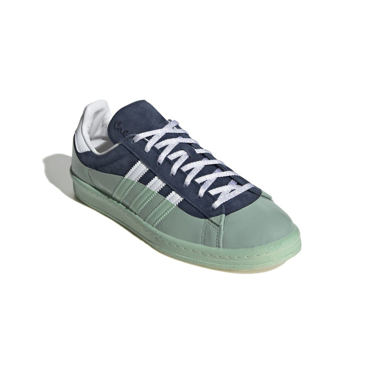 Leather trainers in navy and mint with white Adidas-style stripes and white lace-up