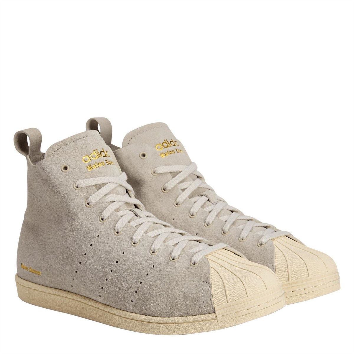 Cream suede high-top sneakers with adidas logo, gold heel tabs, lace-up style.