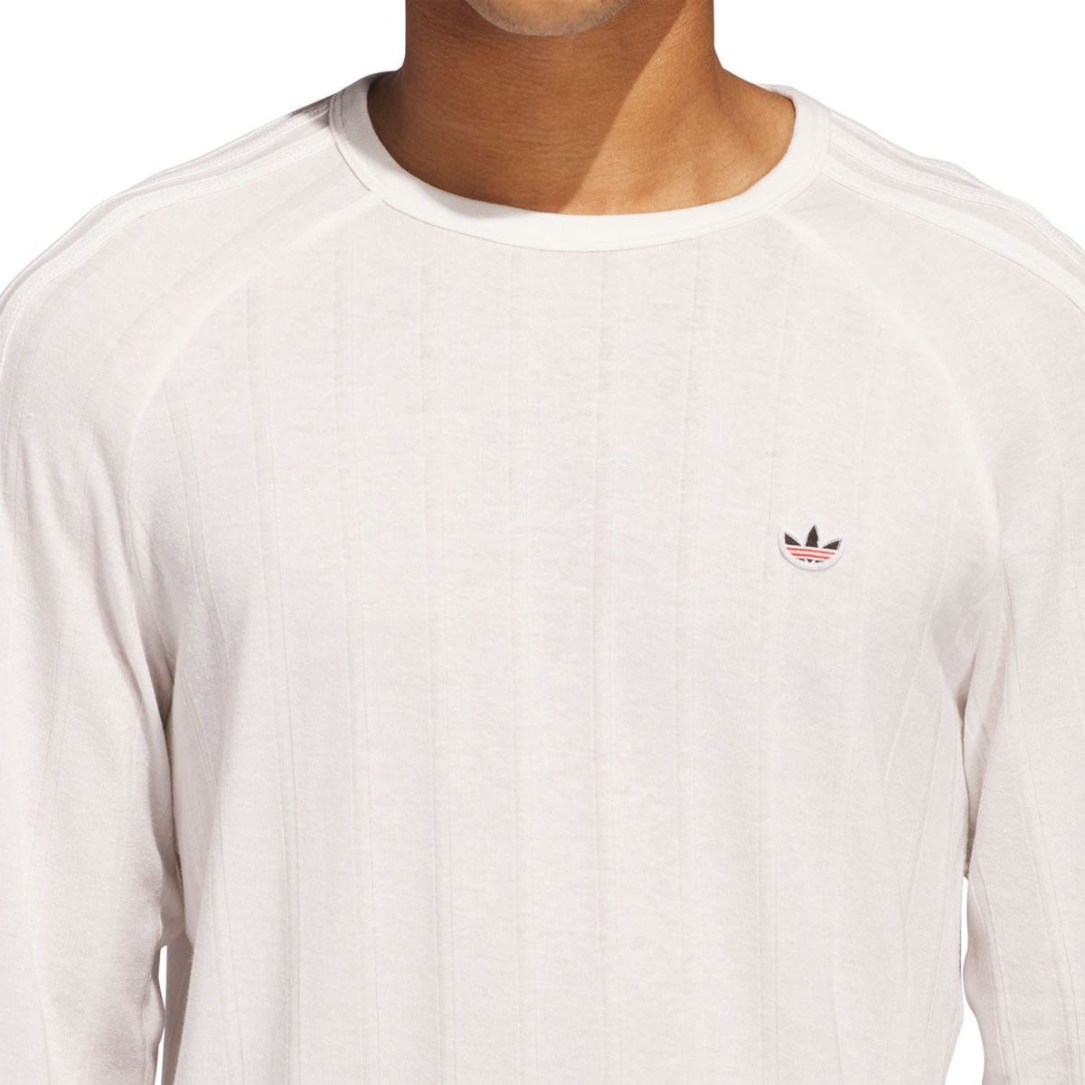 White long-sleeve crewneck t-shirt close-up of chest adidas trefoil logo