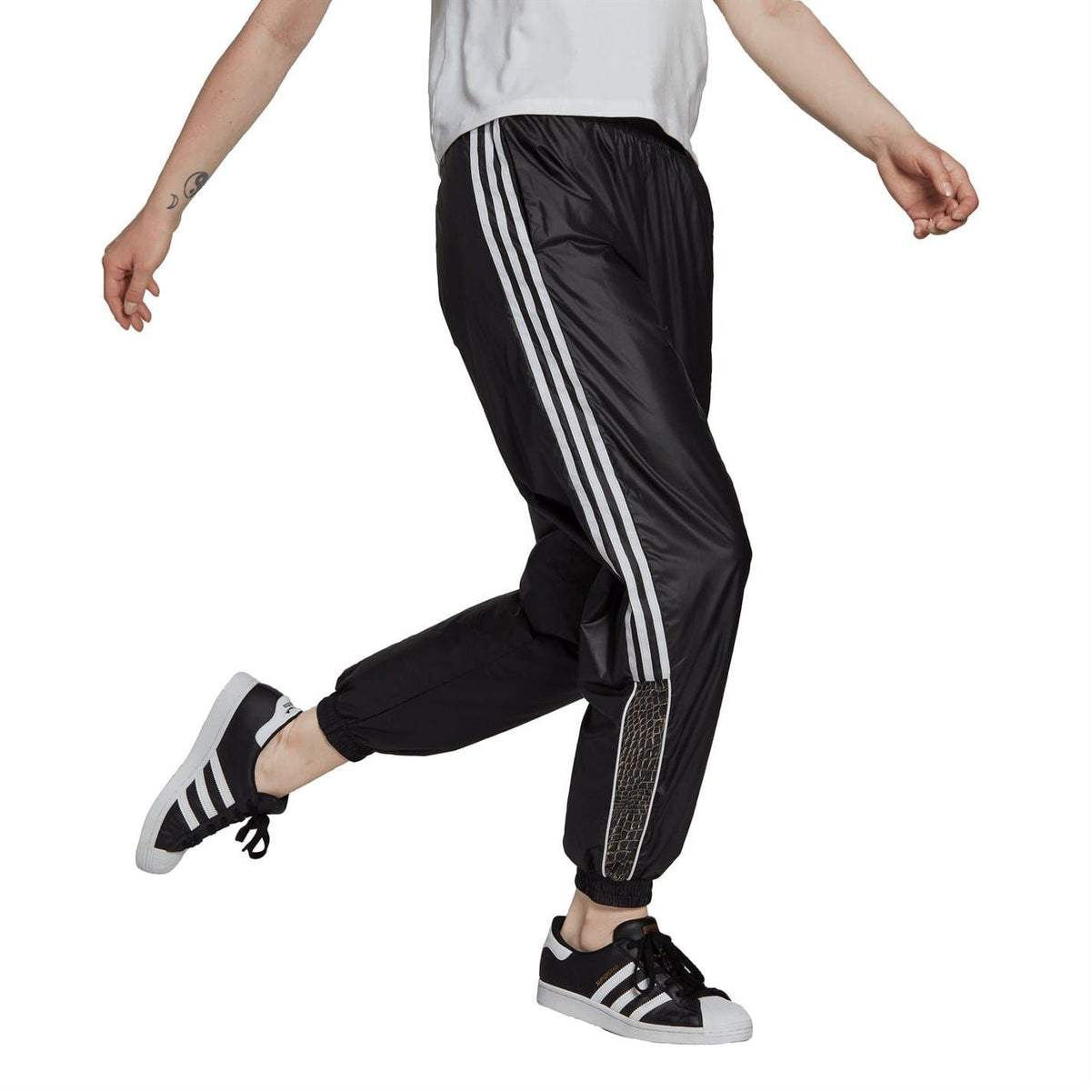 Black jogger track pants with white triple side stripes and elastic waistband