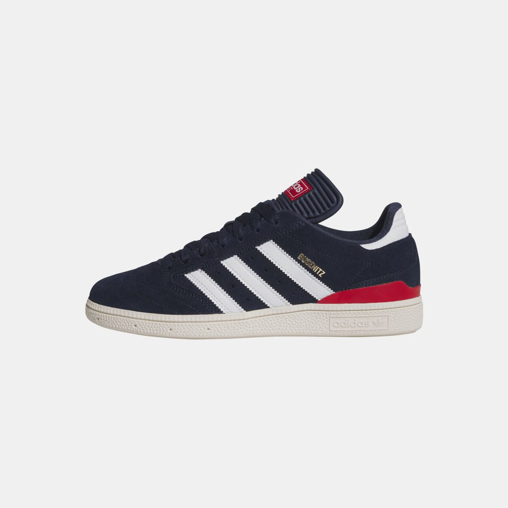 Navy Busenitz low-top sneakers with collar strap, white stripes, and red accent