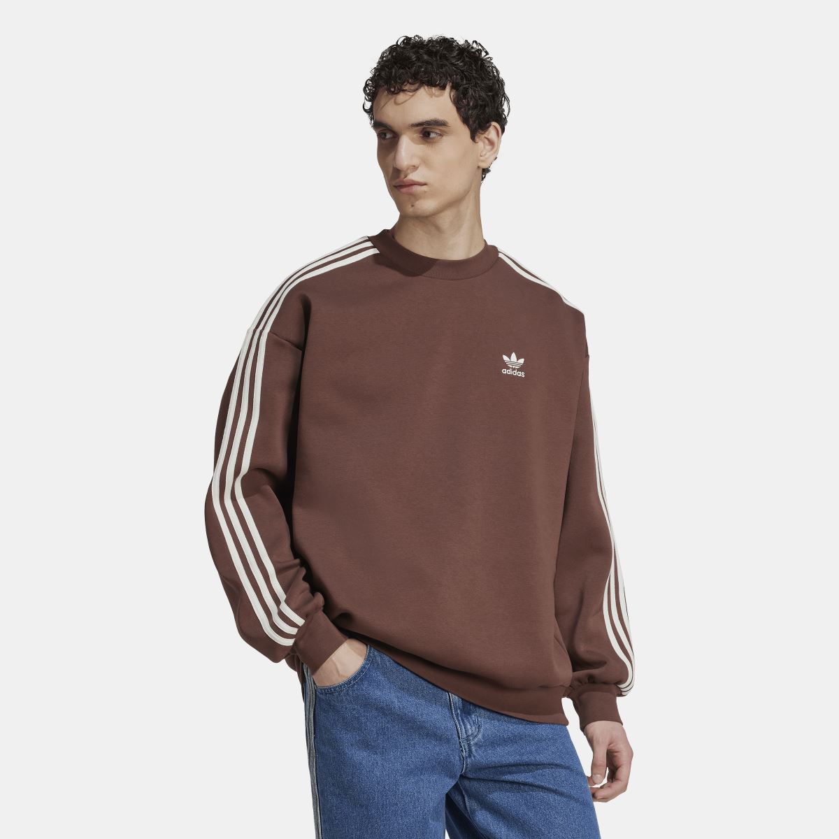 Brown adidas crewneck sweatshirt with three white sleeve stripes and ribbed cuffs