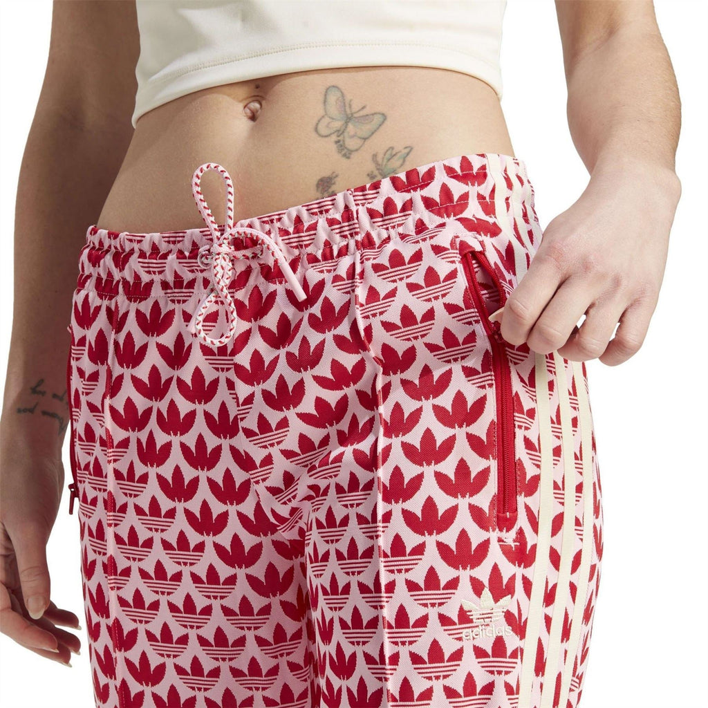Red-and-white logo print track pants with drawstring waistband and ribbed hem
