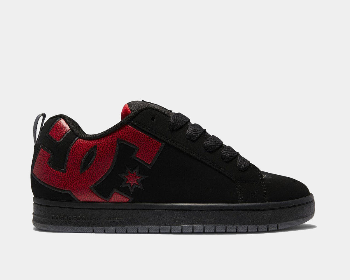 Black suede skate sneaker with red DC logo accents and star detail