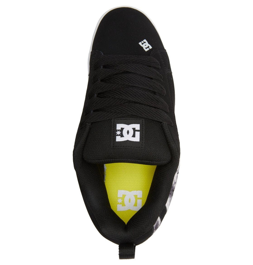 Black low-top sneaker with lace-up tongue and bright yellow heel accent