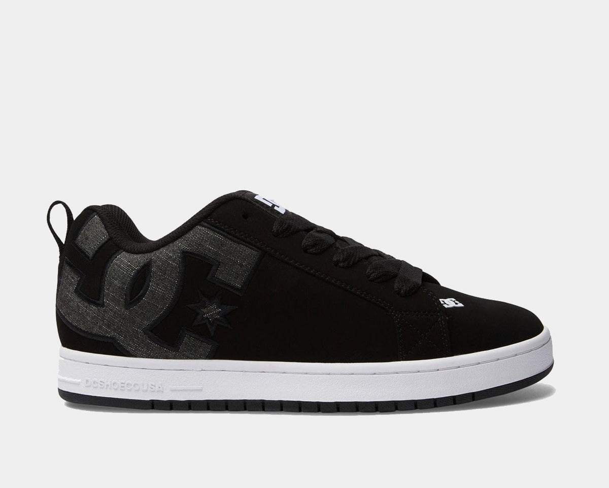 Black low-top sneakers with textured paneling, DC logo on side and lace-up closure