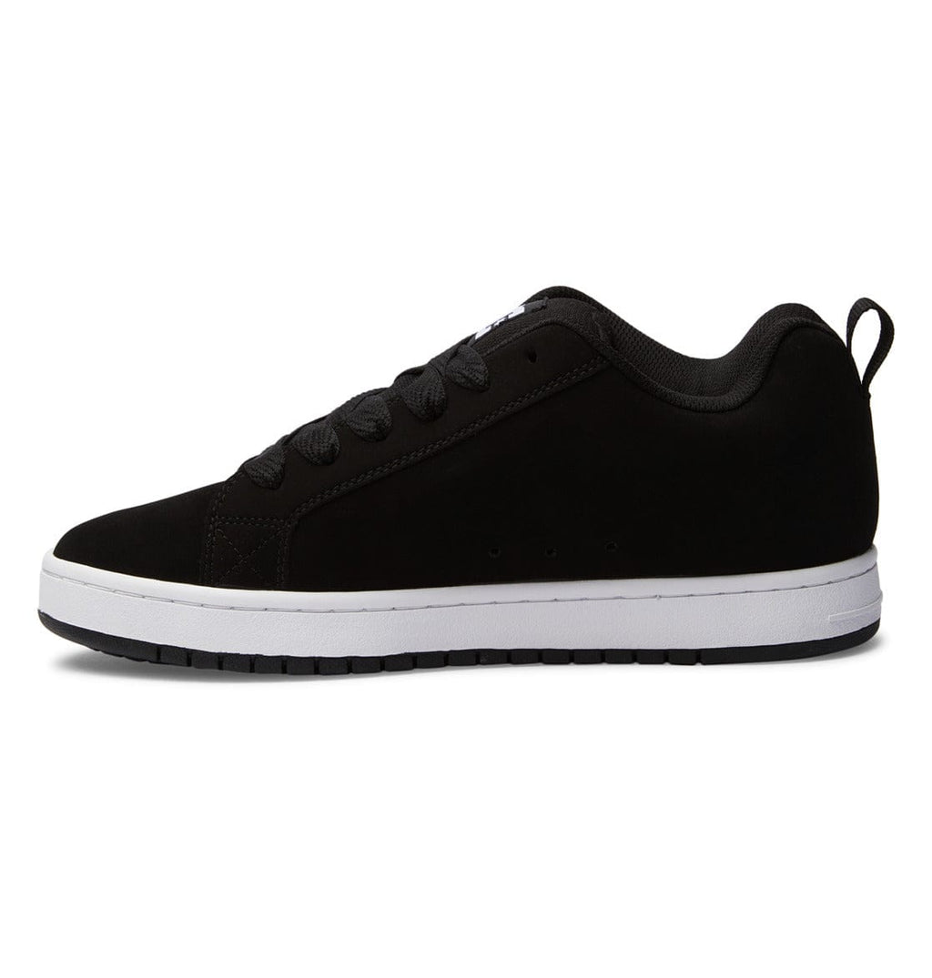 Black low-top sneakers with lace-up front and white midsole detail