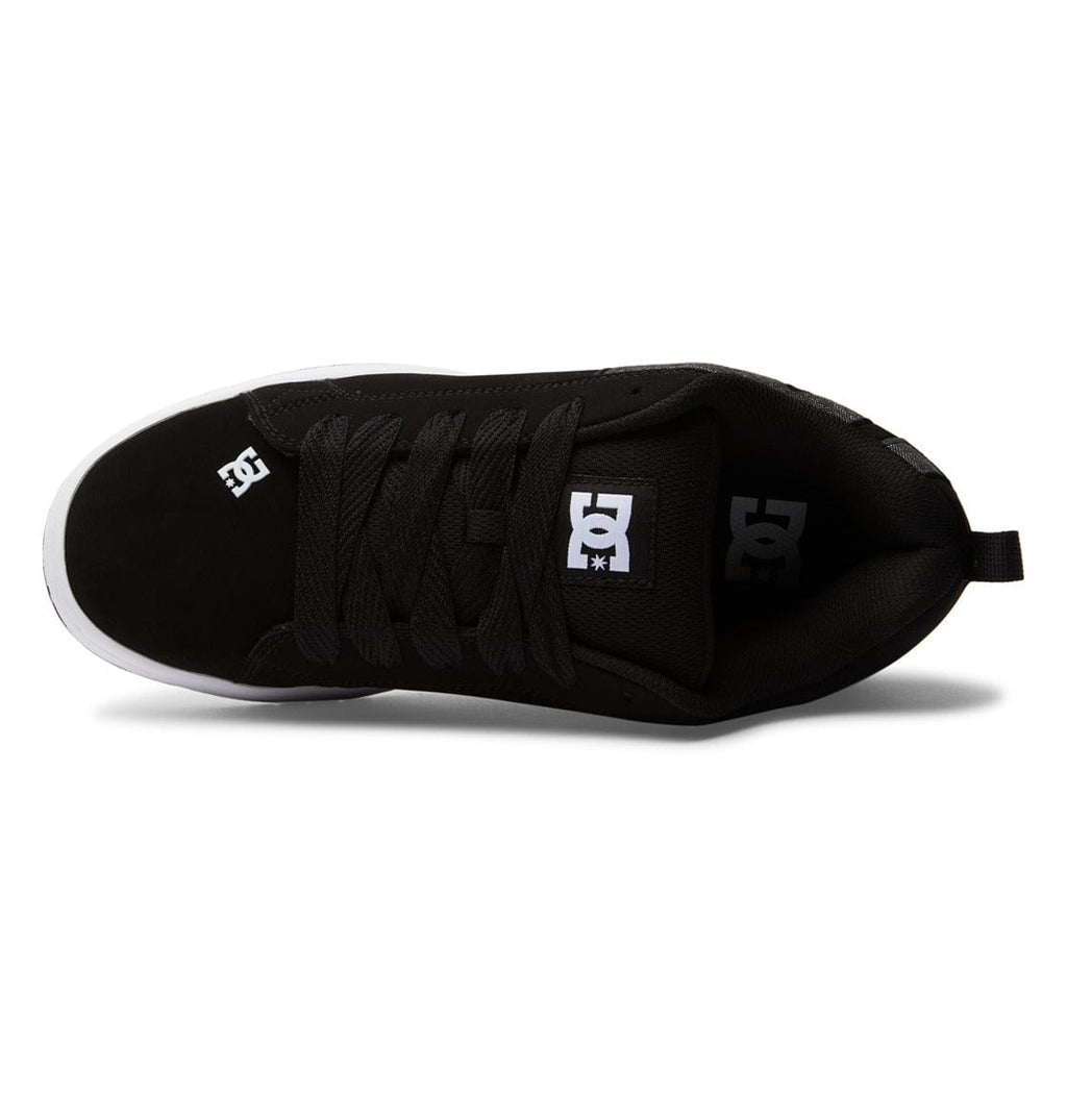 Black low-top sneakers, side view with padded collar, lace-up and DC tongue label