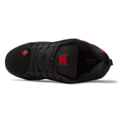 Black sneaker interior side view with black laces and red DC logo on heel