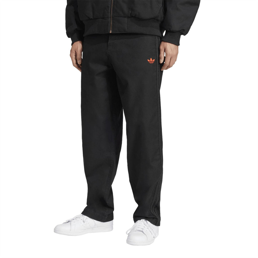 adidas Originals 100T black track pants with red trefoil logo at thigh