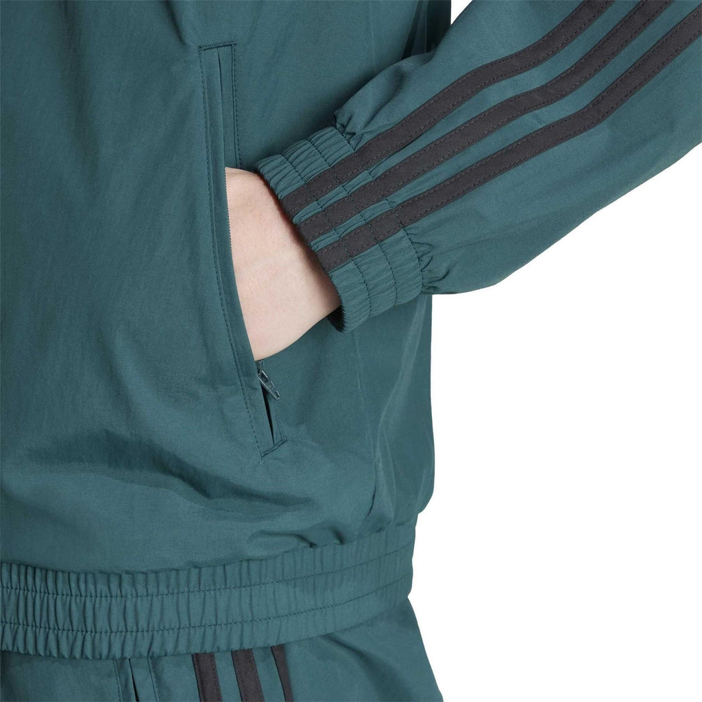 Teal adidas track top sleeve detail with ribbed cuff, zip placket, and three stripes