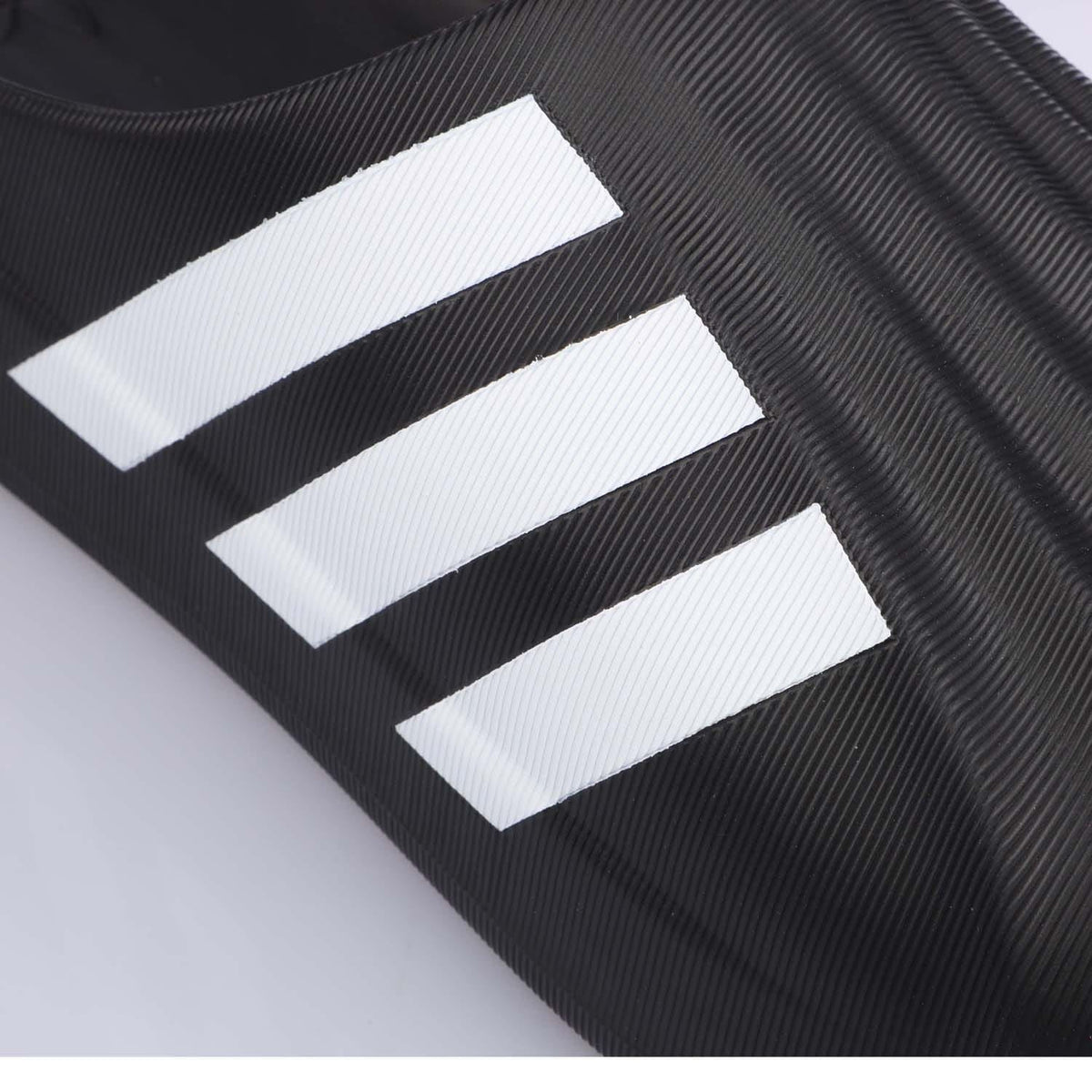 Close-up of black adidas adiFOM Superstar mule upper with white triple stripes