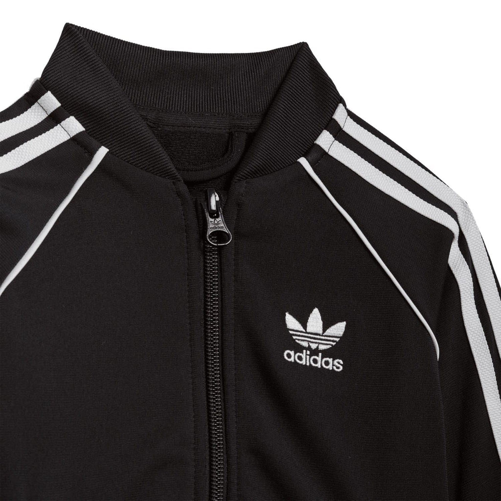 Infant black tracksuit jacket with zip, adidas logo, and white triple stripe detail