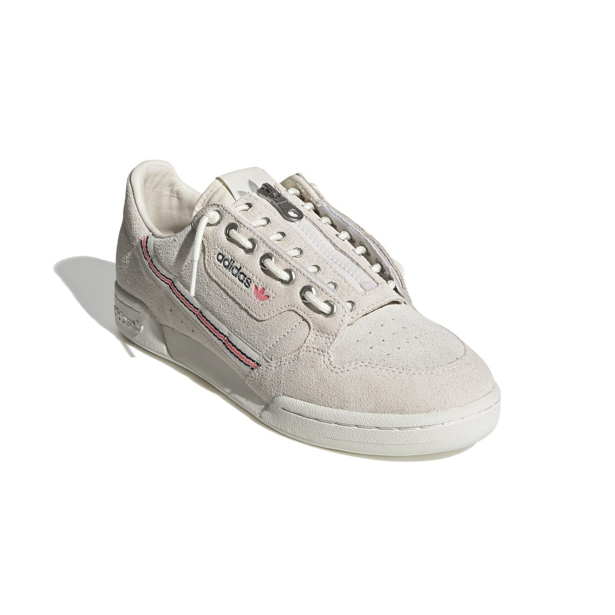 Light beige suede low-top sneakers shown at angle, with lace-up front and adidas logo