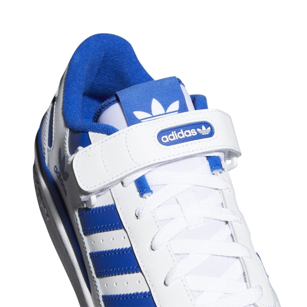 White leather upper with blue lining, adidas logo badge, and strap detail