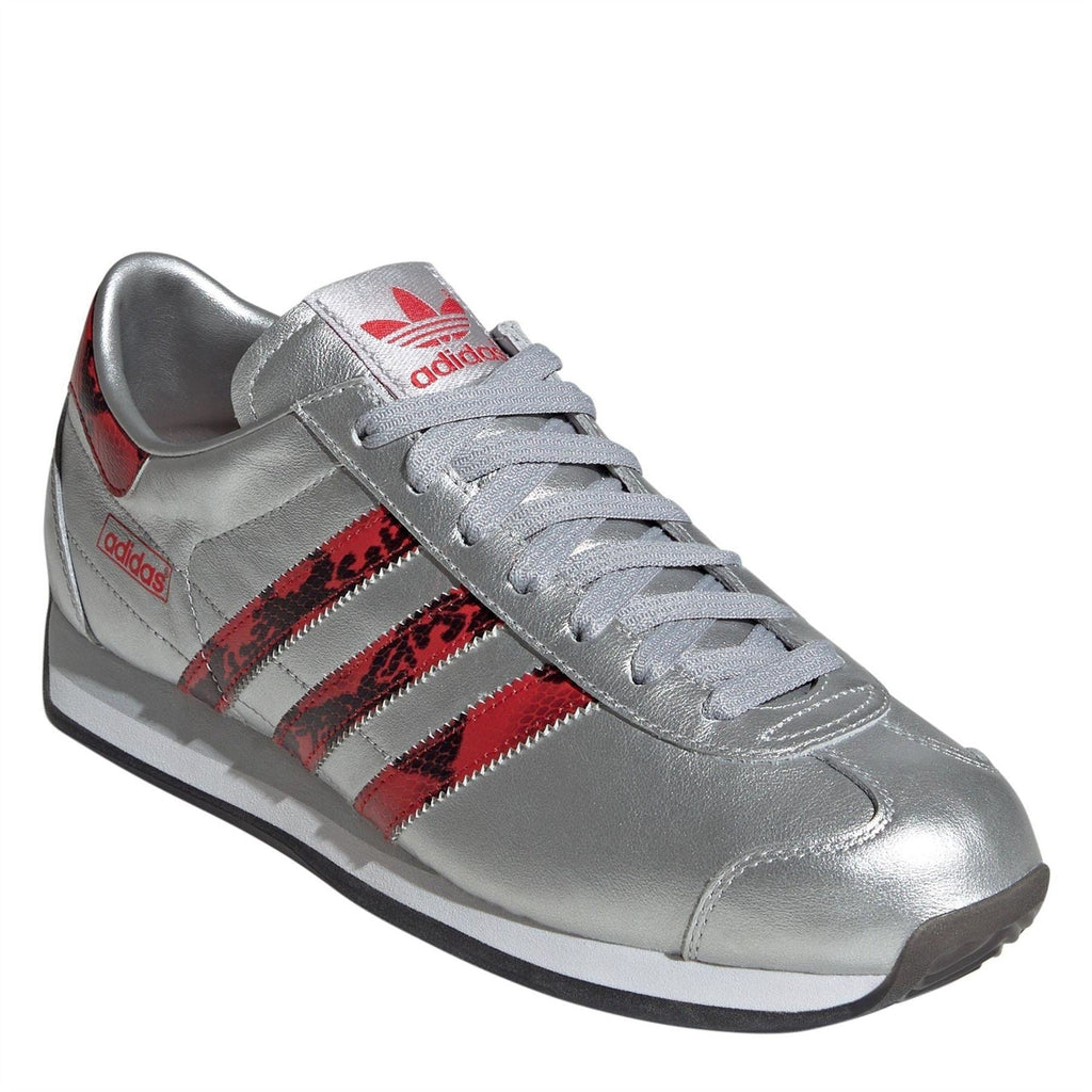 Silver adidas Originals low-top sneaker with red patterned stripes and lace-up front