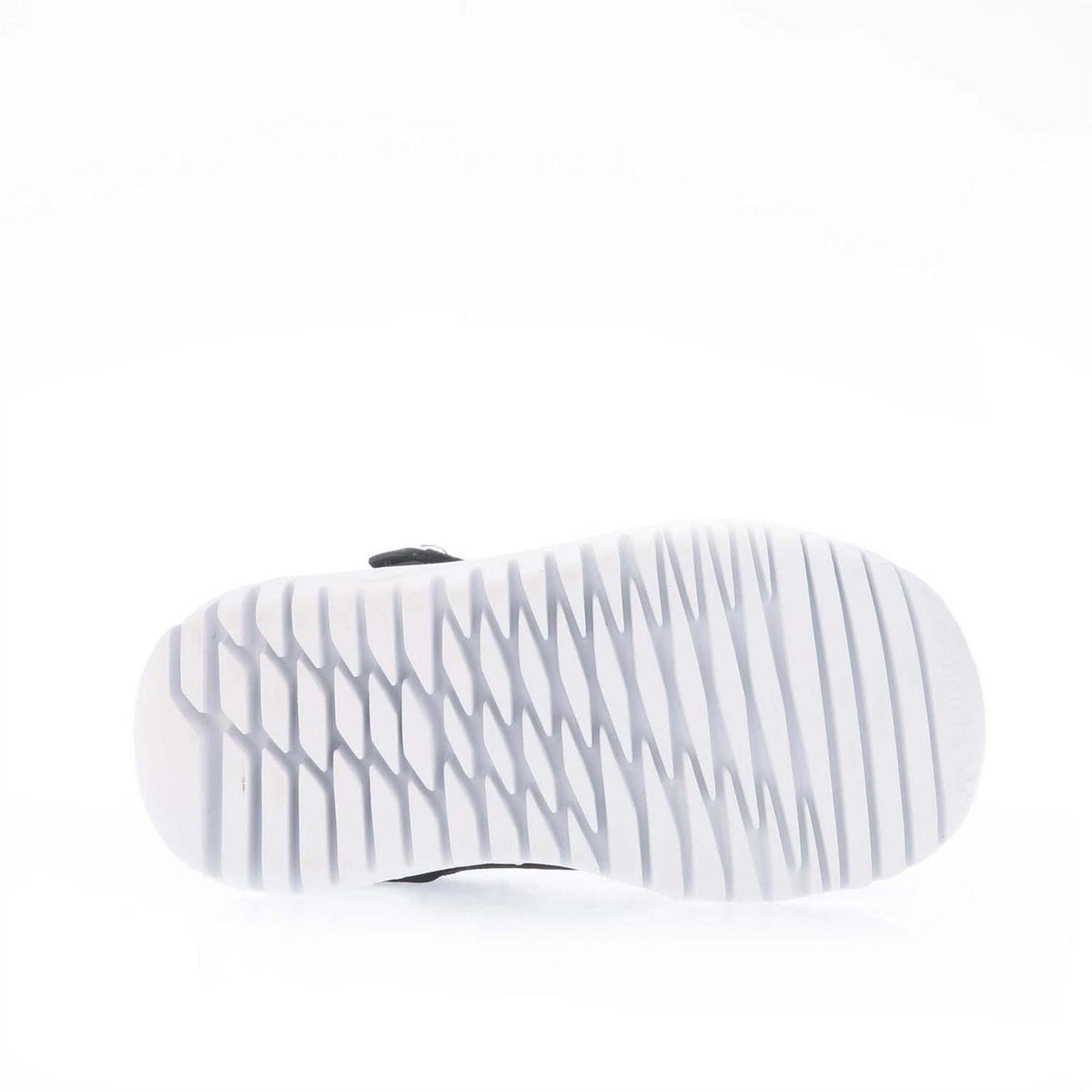 White rubber outsole tread of black trainers