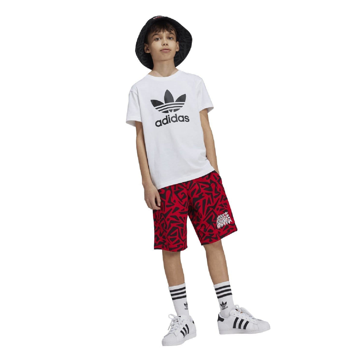 White junior adidas Trefoil t-shirt with chest logo, worn with red patterned shorts