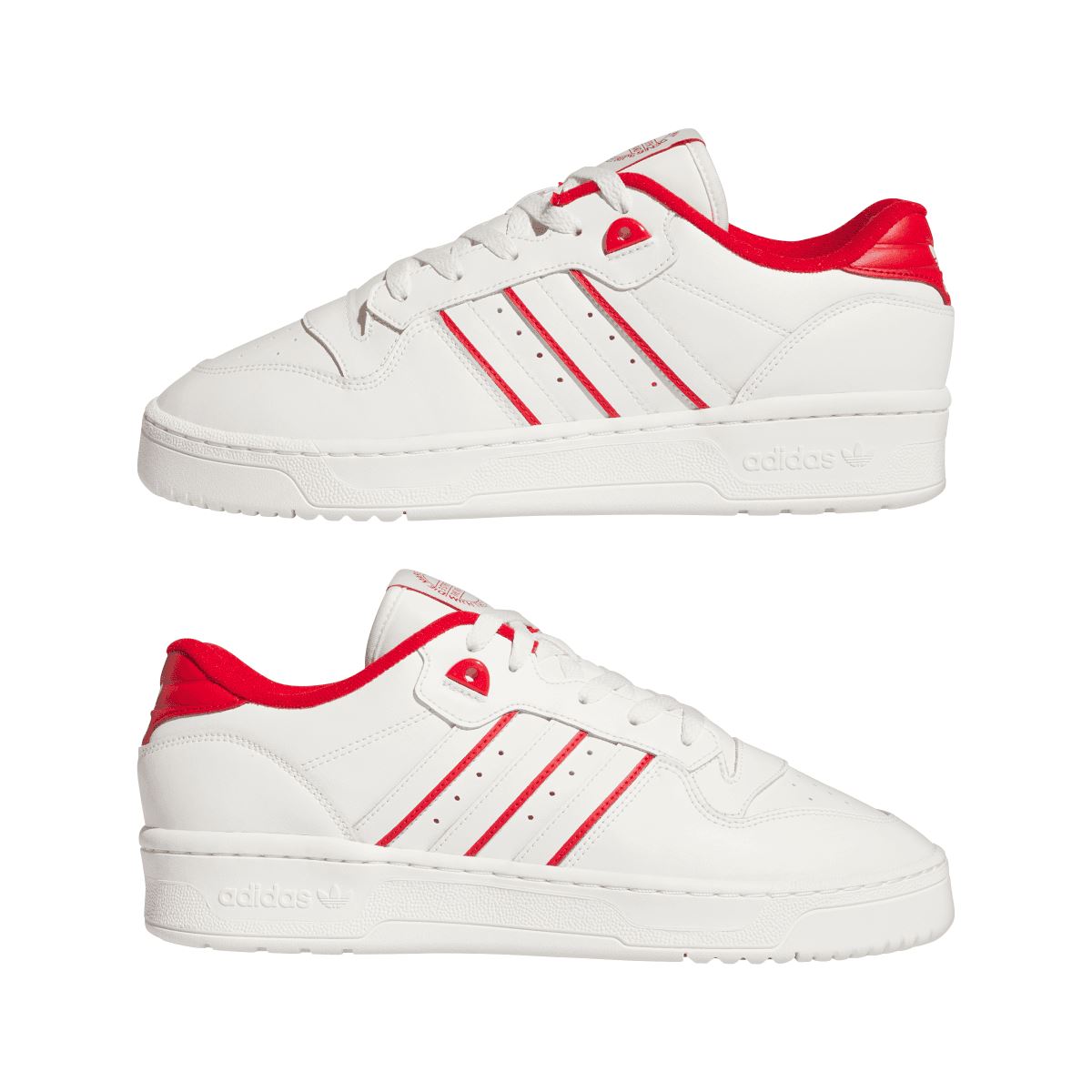 Pair of white low-top lace-up trainers with red accents and three side stripes.