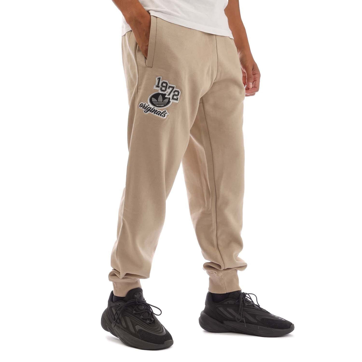 Khaki adidas joggers with '1972 Originals' thigh logo and cuffed hems