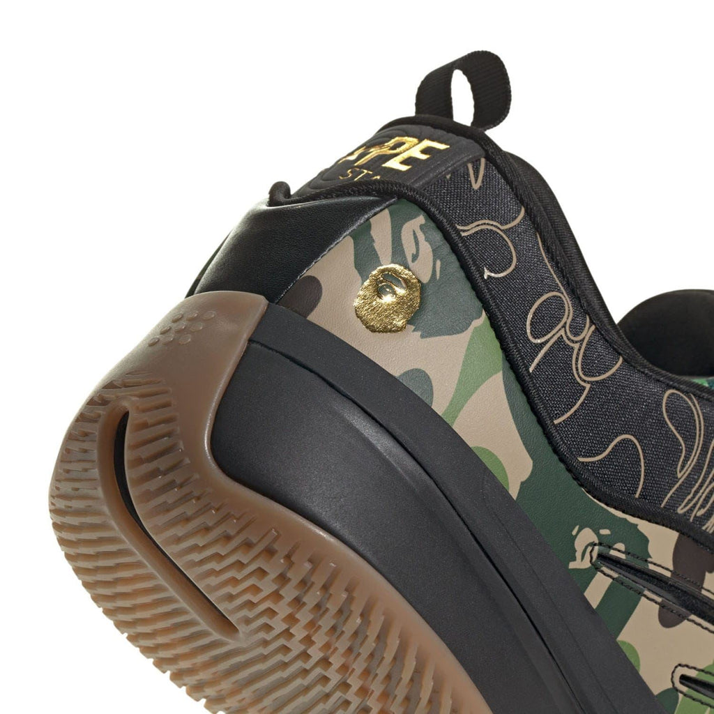 Camouflage trainer upper with gold emblem on side, lace-up front, padded collar