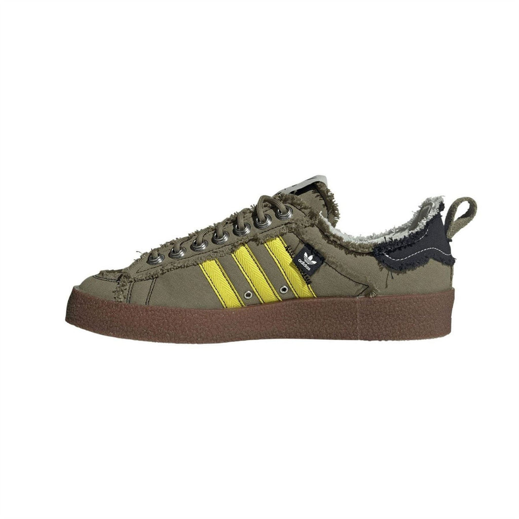 Olive lace-up trainers with yellow Three Stripes, fleece-lined collar, and brown sole