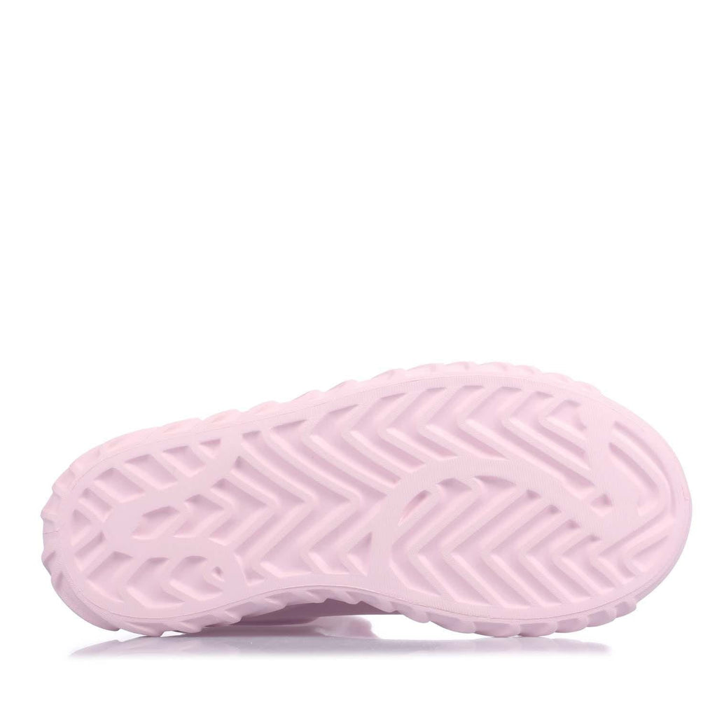 Pink outsole view of mid-top boots with chevron tread pattern