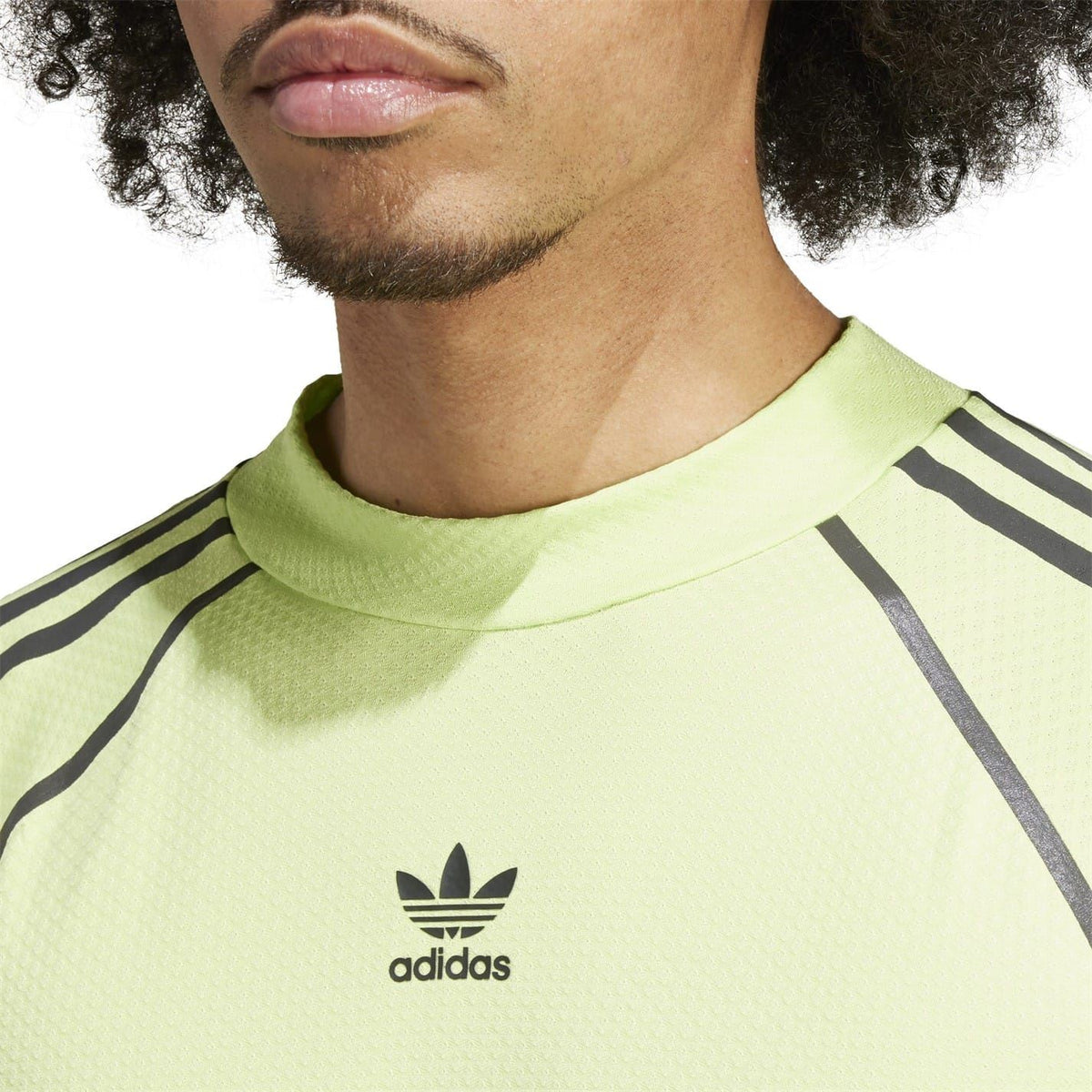 Lime green t-shirt chest logo with black raglan stripes and adidas trefoil