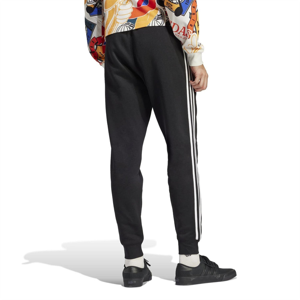 Black slim joggers with white side stripes and ribbed cuffs, full-body view
