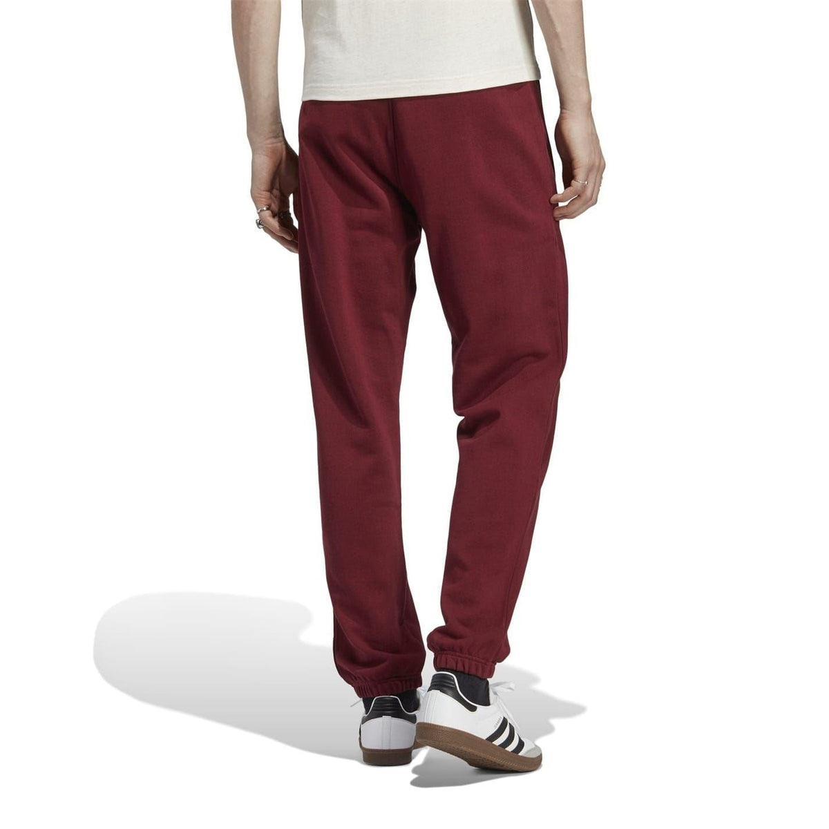 Burgundy tapered track pants with elastic cuffs and drawstring-free waistband