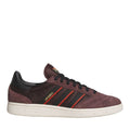 Brown and black low-top skate trainers with red stripes, black laces, and white rubber sole