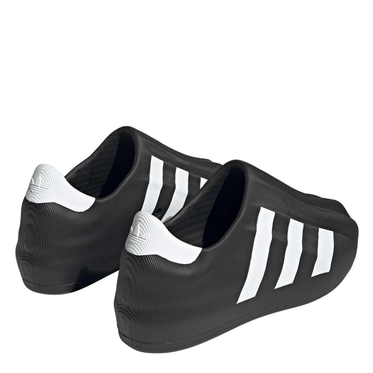 Black slip-on sneakers, side view, with white stripe accents and white heel lining
