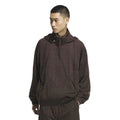 Brown zip-up hooded jacket with textured perforated chevron pattern and elastic cuffs