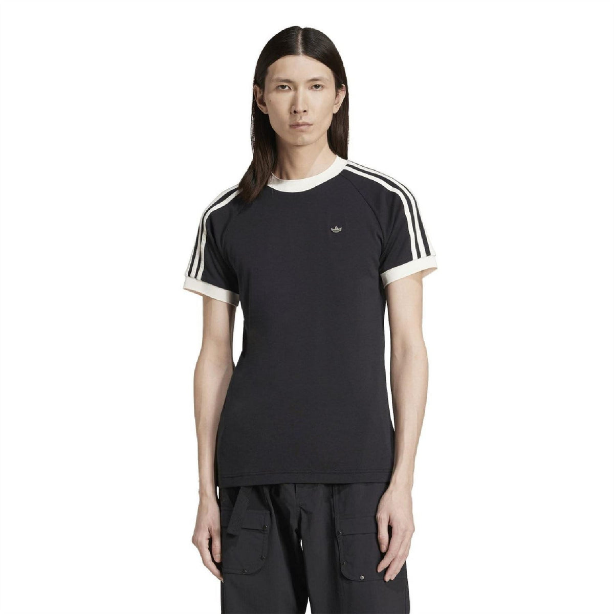 Black adidas Originals T-shirt on model, white ribbed collar and three-stripe sleeves