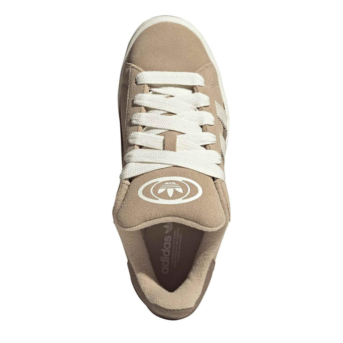Beige suede trainers with white laces and tongue logo, shown from front