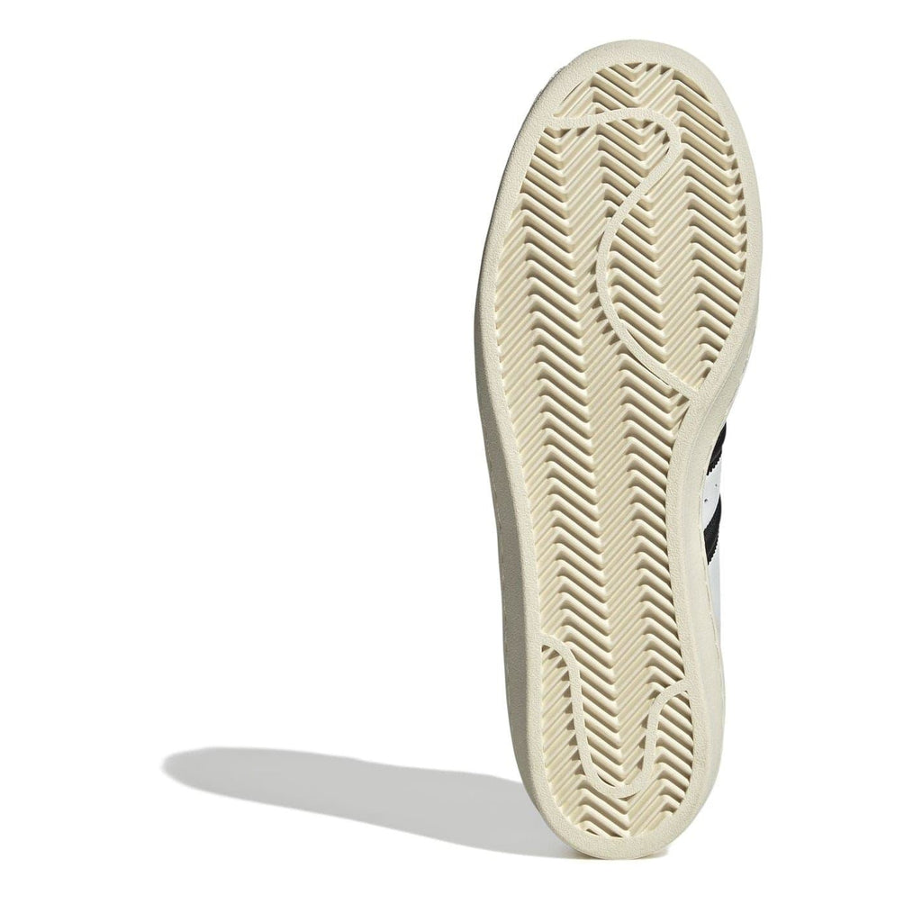 White sneaker outsole with herringbone tread, beige rubber sole