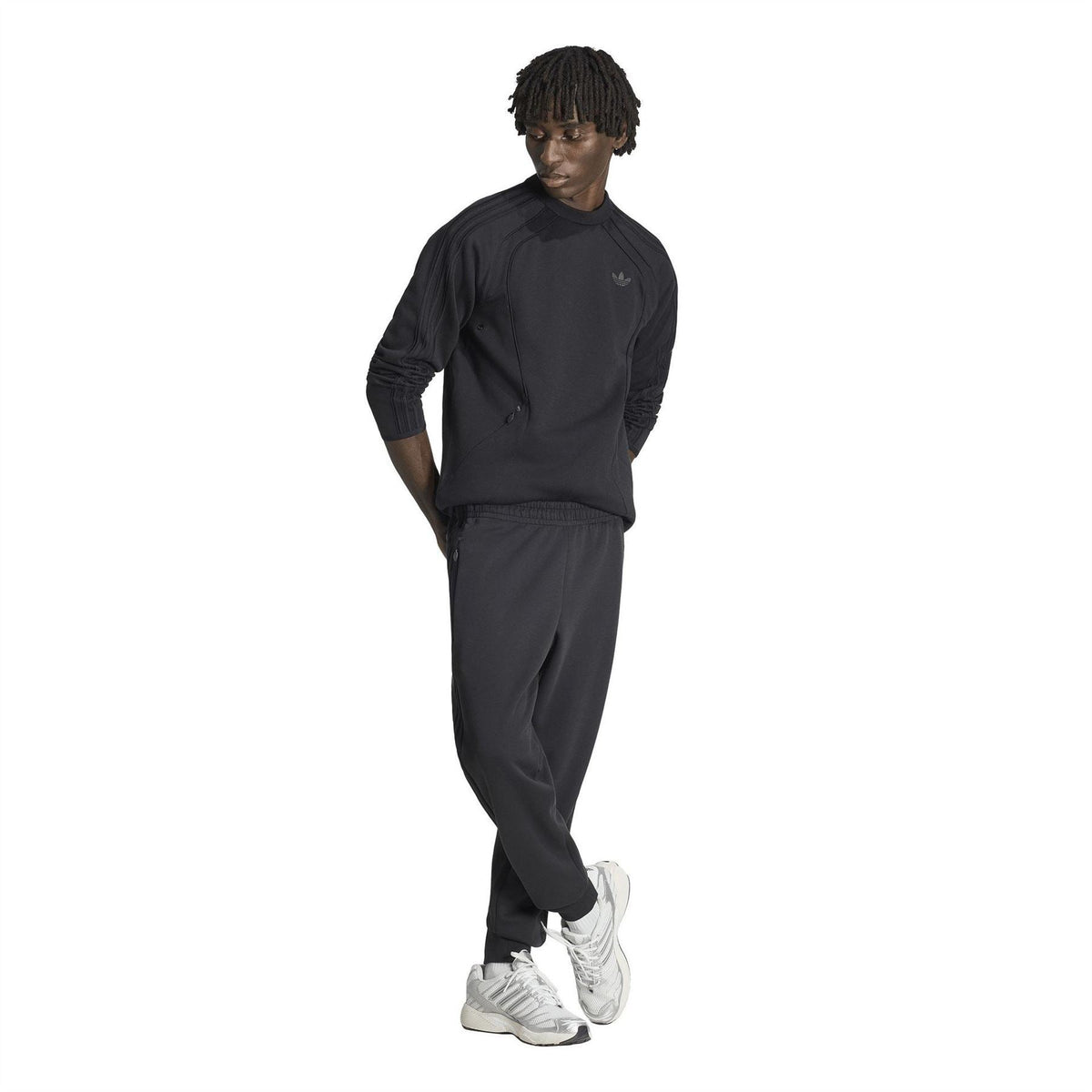 Black track pants with elastic waistband, side stripes and adidas trefoil logo
