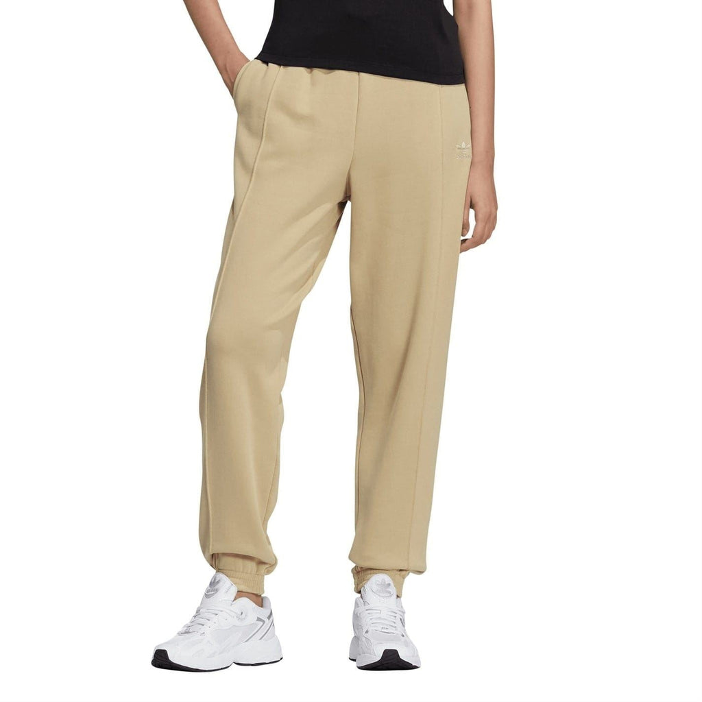 Beige adidas Originals sweatpants with tapered legs and elastic ankle cuffs