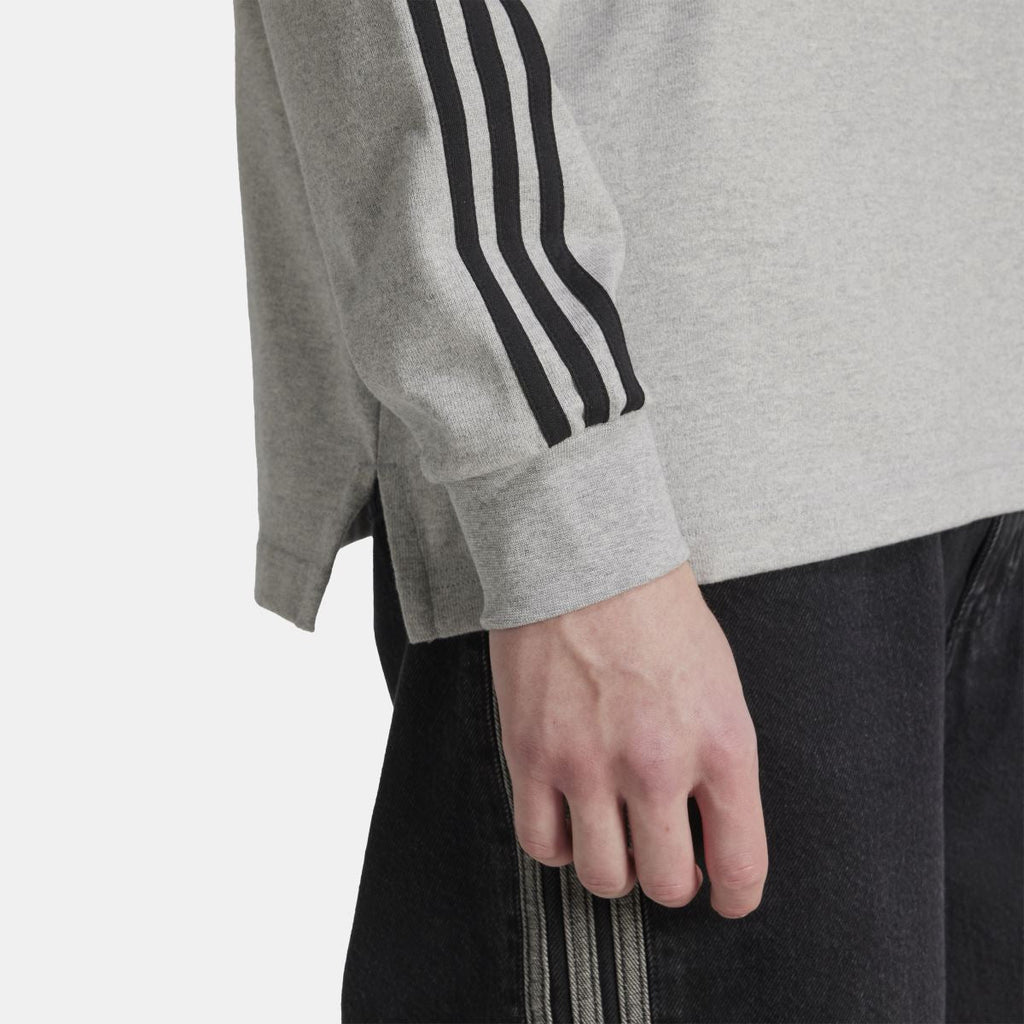 Grey sleeve cuff with black three-stripe detailing and ribbed hem
