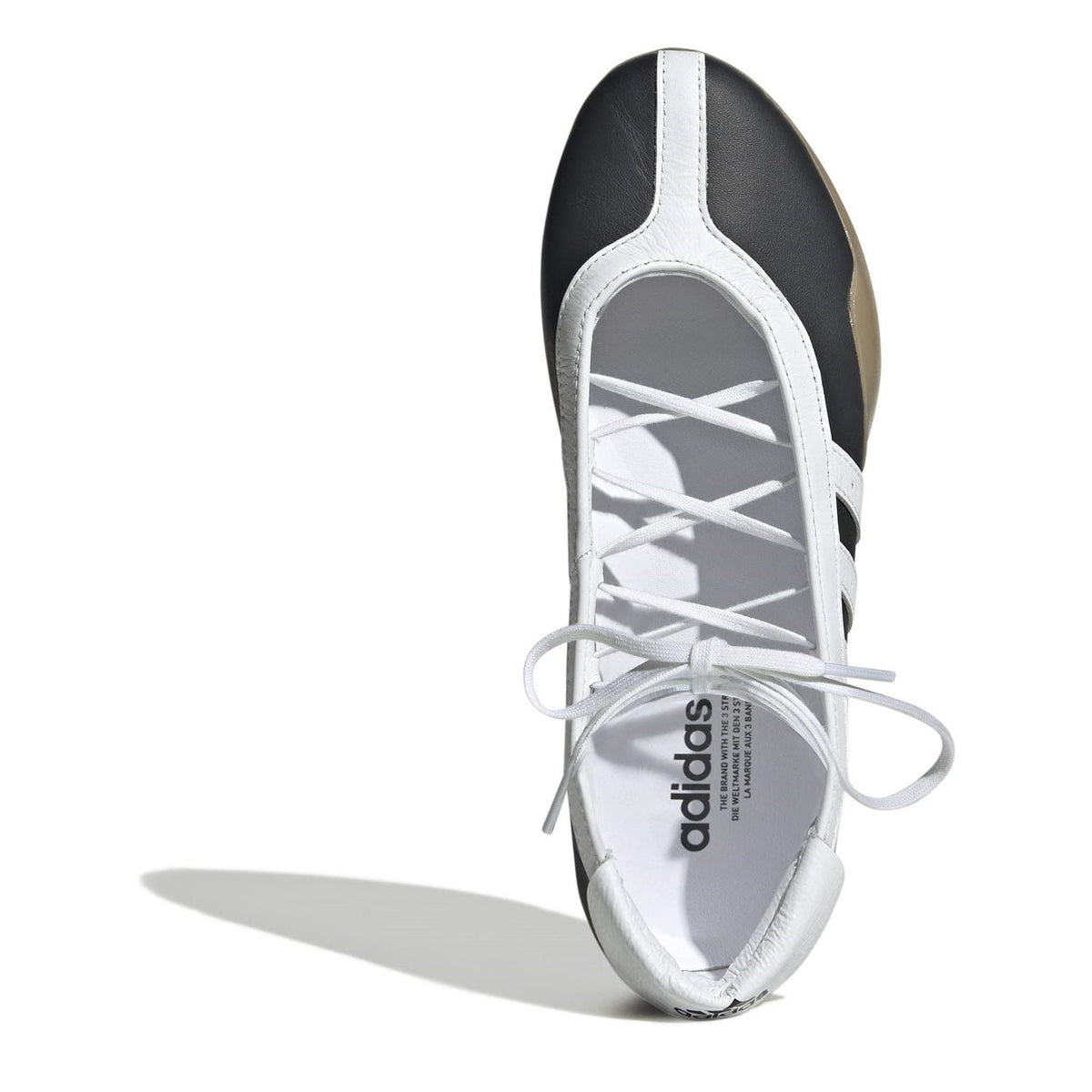 Taekwondo sneakers with black collar, white laces, and adidas on the insole