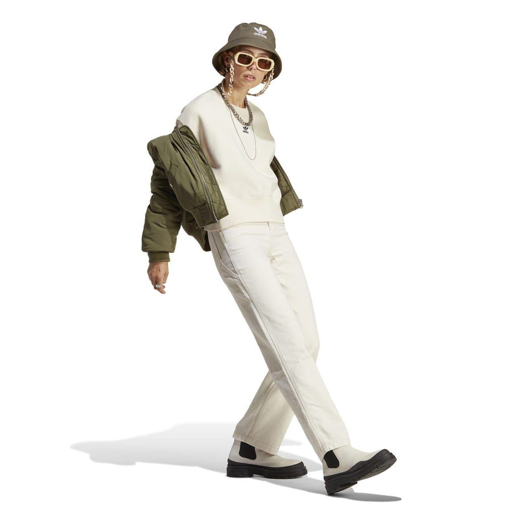 Cream crewneck sweatshirt with trefoil logo, styled on moving model.