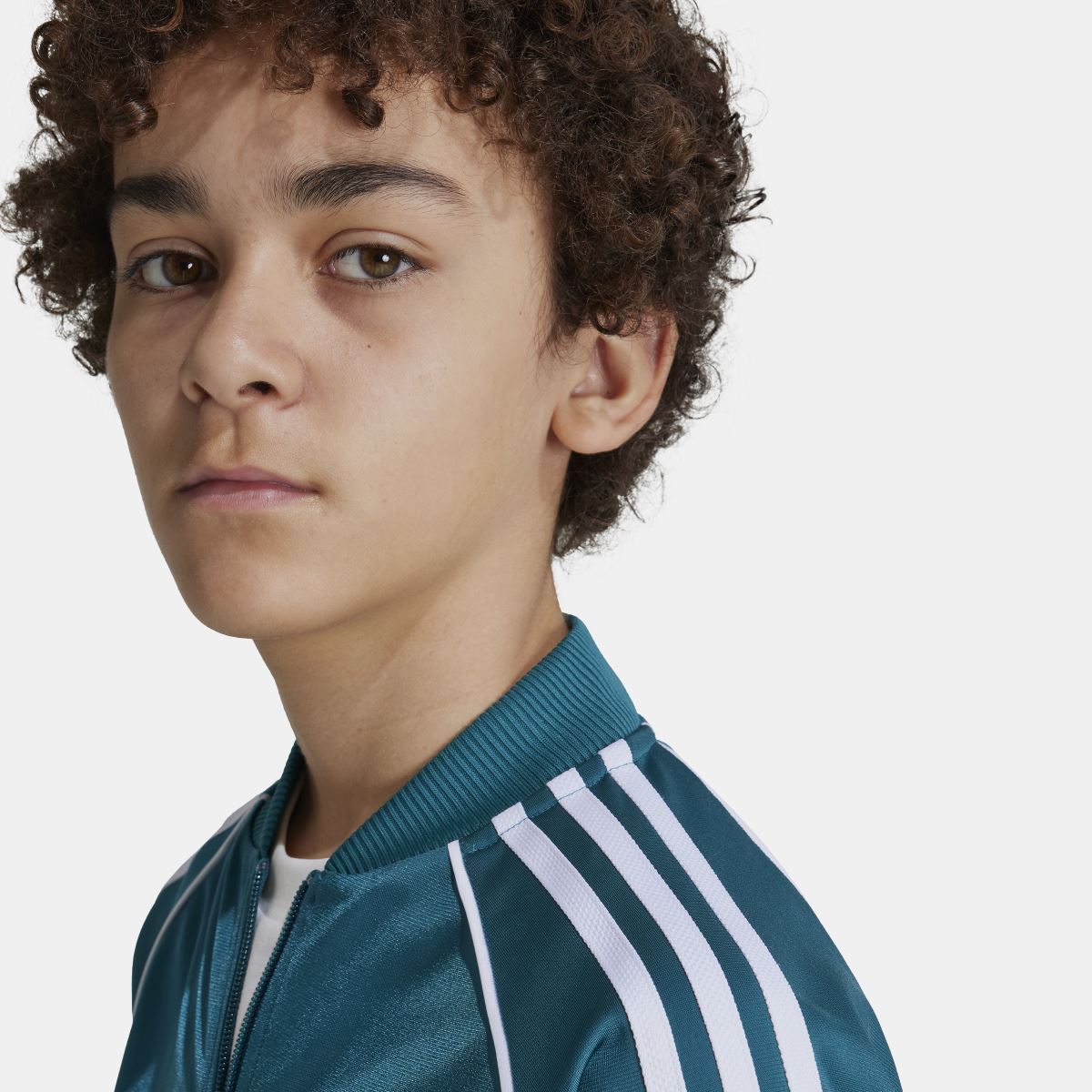 Teal track jacket collar with white triple stripe panel and small adidas logo.